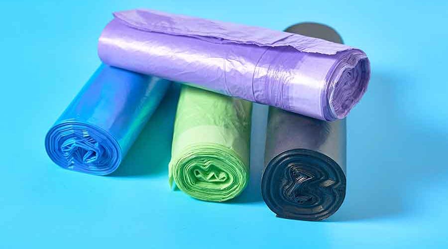 Polythene-Packaging-Bags-rolls-of-disposable-plastic-garbage-bag-on-blue-background